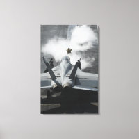 A flight deck director signals an F/A-18F