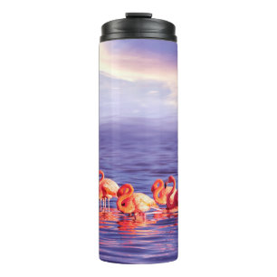 A flock of beautiful pink flamingos against a purp thermal tumbler