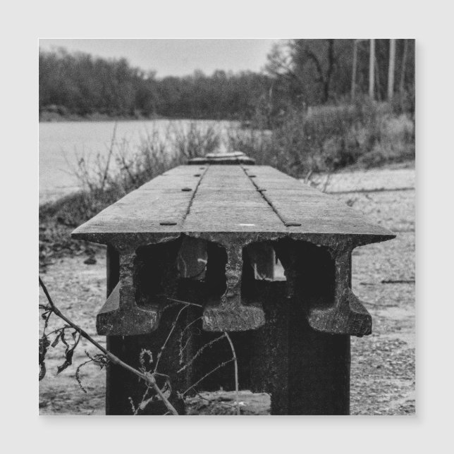 A forgotten old rail seat along a river. (Front)