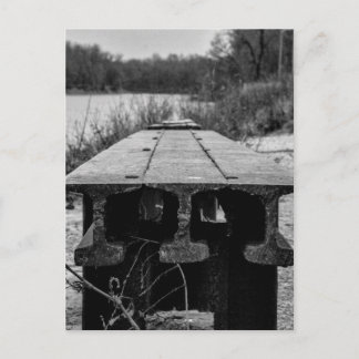 A forgotten old rail seat along a river. postcard