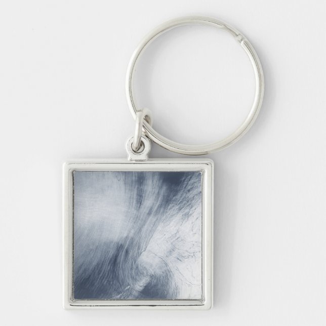 A giant whirlpool cloud swirls above the sea keychain (Front)