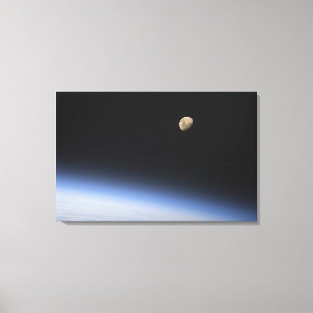 A gibbous moon visible above Earth's atmosphere 2 Canvas Print (Front)