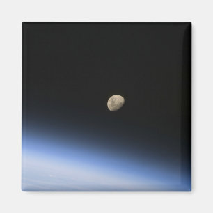 A gibbous moon visible above Earth's atmosphere 2 Magnet