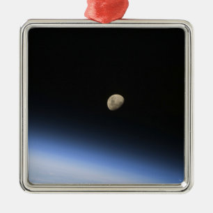 A gibbous moon visible above Earth's atmosphere 2 Metal Ornament