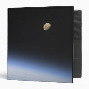 A gibbous moon visible above Earth's atmosphere Binder
