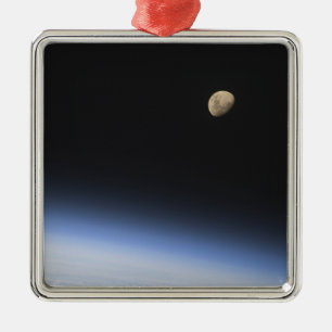 A gibbous moon visible above Earth's atmosphere Metal Ornament