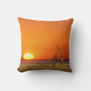 A Giraffe couple walks into the sunset, in Throw Pillow