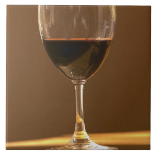 A glass of red Chateau Belgrave in sunlight - Tile