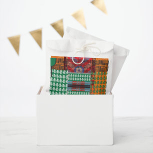 a green and black pattern with a tree in the middl favour bag