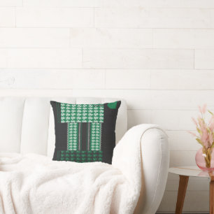 a green and black pattern with a tree in the middl throw pillow