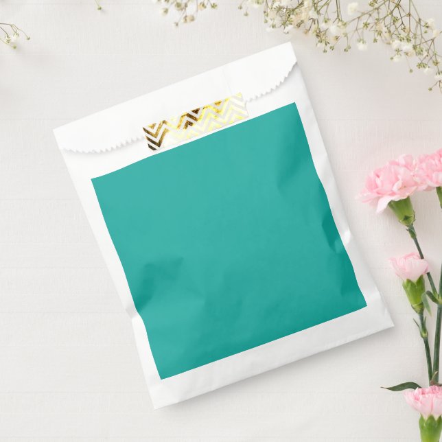 a green background with a  favour bag (Sealed)