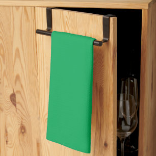 a green background with a kitchen towel