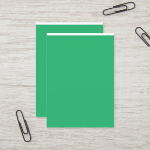 a green background with a white border business card