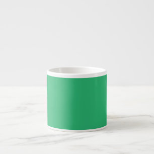 a green background with a white border espresso cup