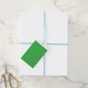 a green background with a white border gift tags
