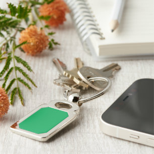 a green background with a white border keychain