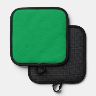 a green background with a white border pot holder