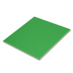a green background with a white border tile<br><div class="desc">The image is a bright blue square with a uniform colour and a smooth texture. It stands out against the background with a striking visual contrast.</div>