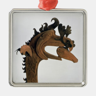 A griffin holding a deer in its beak metal ornament