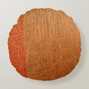a hay cylindrical bale in a field on round pillow