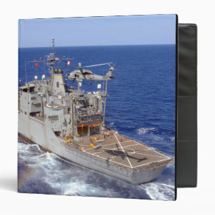 A helicopter clears the flight deck binder