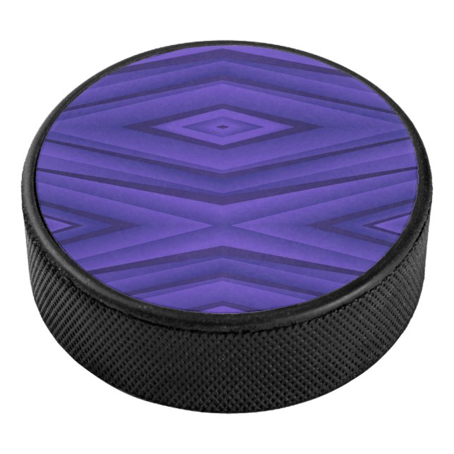 A hockey puck with a vibrant purple geometric  (3/4)