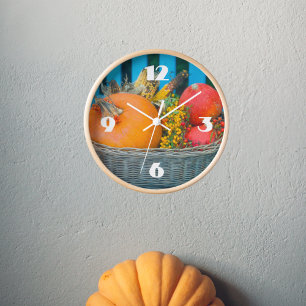 A holiday basket with pumpkins  clock