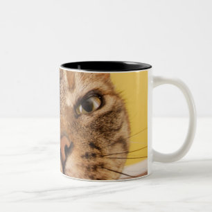 A humourous little cat sits on a stool Two-Tone coffee mug