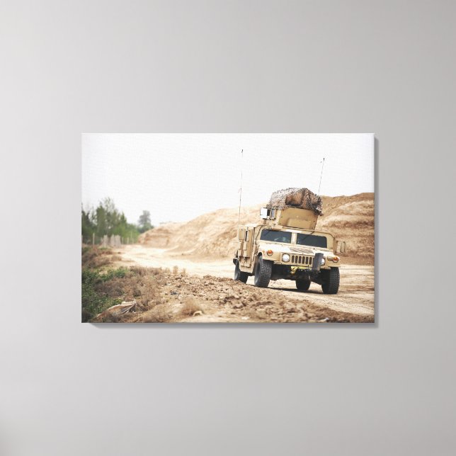 A Humvee conducts security Canvas Print (Front)
