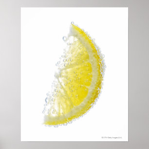 A juicy ripe organic lemon wedge fruit submerged poster