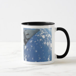 A KC-135 Stratotanker refuels a B-2 Spirit Mug