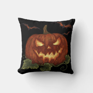A large pumpkin with glowing eyes and bats throw pillow