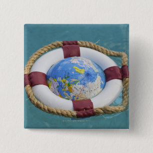 A life preserver and world globe floating 2 inch square button