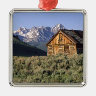 A log cabin and the Sawtooth Mountains in Metal Ornament