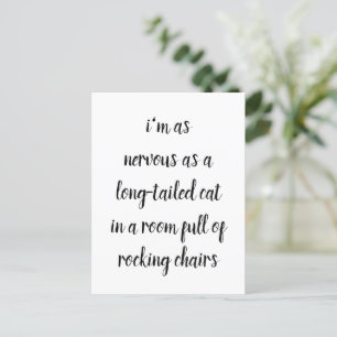 a long tailed cat in a room full of rocking chairs postcard