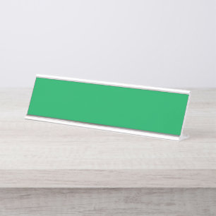 A lush green fern with delicate, intricately patte desk name plate