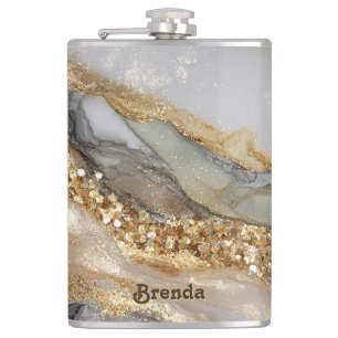A luxurious gold and white marble background hip flask