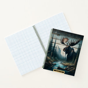 A majestic moose standing by a tranquil riverbank notebook