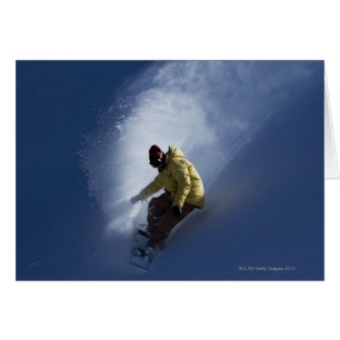 A male snowboarder catches last light on a