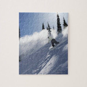 A male snowboarder ripping powder in Idaho. Jigsaw Puzzle