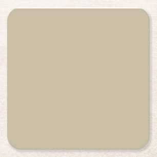 a man in a suit and tie standing in front of a wal square paper coaster