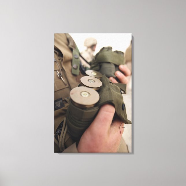A Marine cradles handfuls of 40 mm grenades Canvas Print (Front)