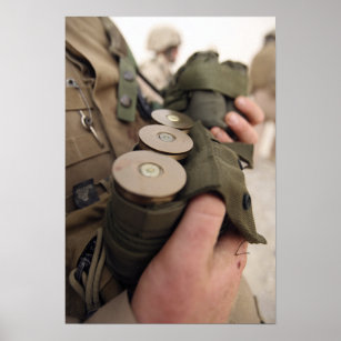 A Marine cradles handfuls of 40 mm grenades Poster