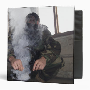 A marine fills the gas chamber with more CS gas Binder