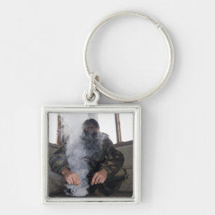 A marine fills the gas chamber with more CS gas Keychain