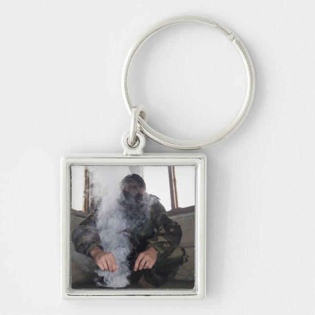 A marine fills the gas chamber with more CS gas Keychain (Front)