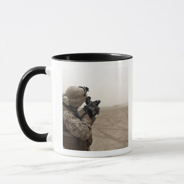 A Marine fires the M-32 Mug (Left)