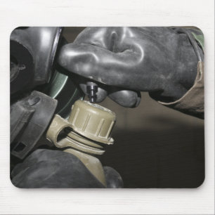 A Marine inserts a drinking tube into his cante Mouse Pad