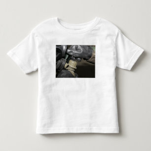 A Marine inserts a drinking tube into his cante Toddler T-shirt