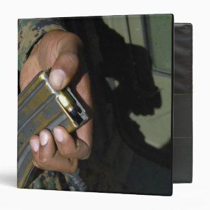 A Marine loads blank ammunition rounds Binder